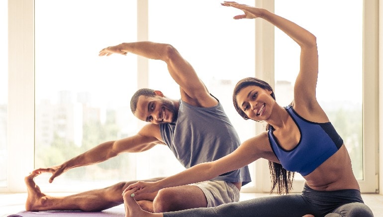 Valentine’s Day: How couples yoga helps to relieve stress in your relationship
